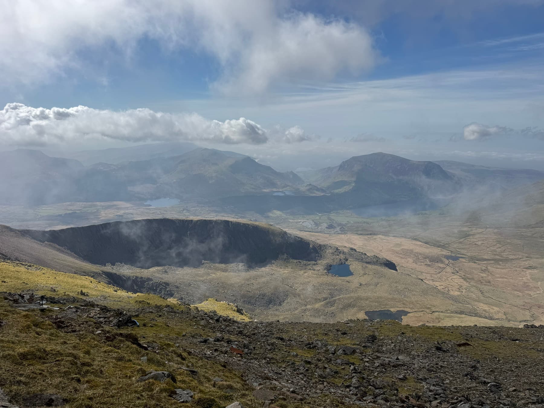 Pan panoramic view from the summit of Mount Snowdon, highlighting the remote and challenging terrain of the UK's highest operational power installation.