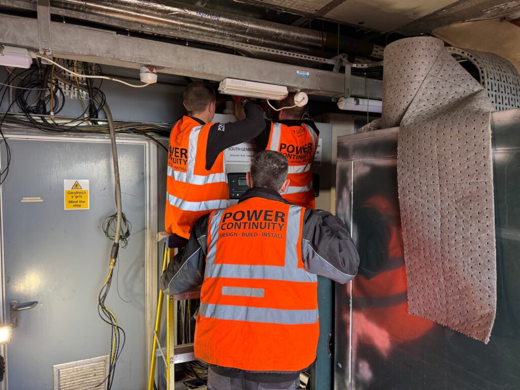 Power Continuity engineers on site installing and wiring the South Generator control panel inside the summit plant room at Mount Snowdon.
