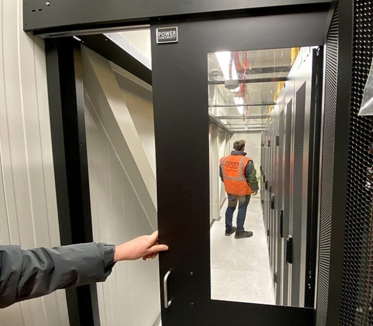Engineers in a data center built by power continuity