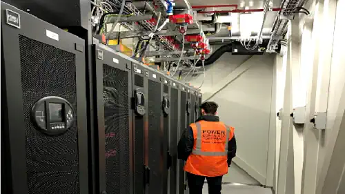 engineer in a data center built by power continuity