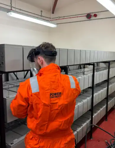 Engineer working on UPS batteries.