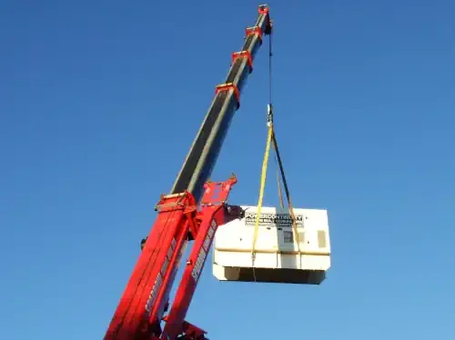 Power continuity 100 kVA diesel generator being lifted by a crane
