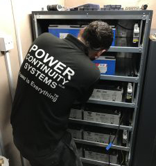 Power continuity engineer changing batteries
