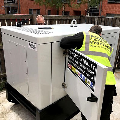 Power continuity engineer commissioning a canopied diesel generator 200kva