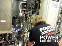Power continuity engineer installing a ups