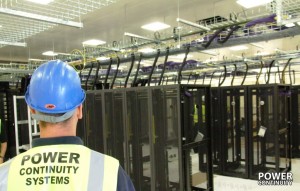 Power continuity engineer installing comms room