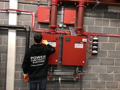 Power continuity engineer installing fire suppression system