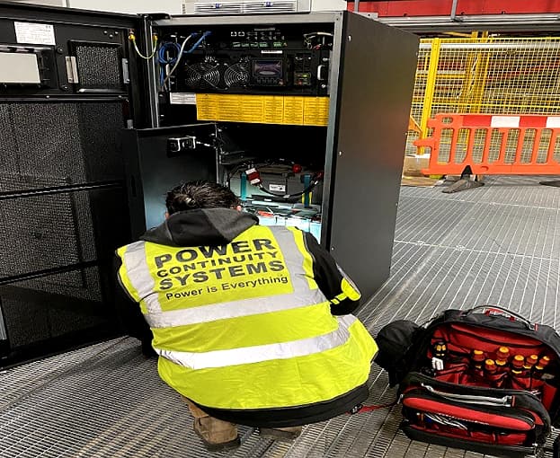 Power continuity engineer installing ups
