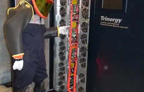 Power continuity engineer servicing a ups in an insulated rubber suit