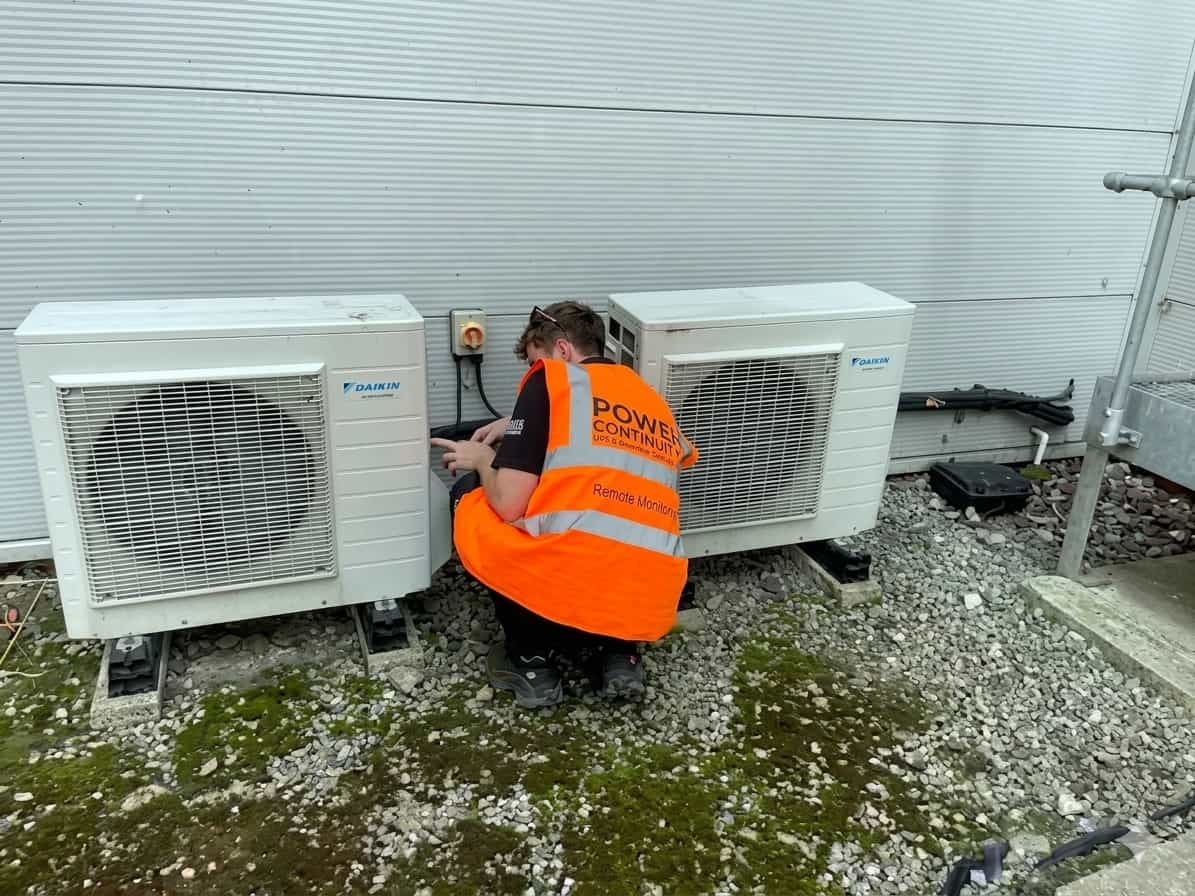 Power continuity engineer servicing air conditioning units