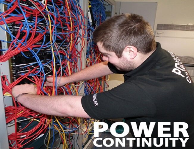 Power continuity engineer working in a server room