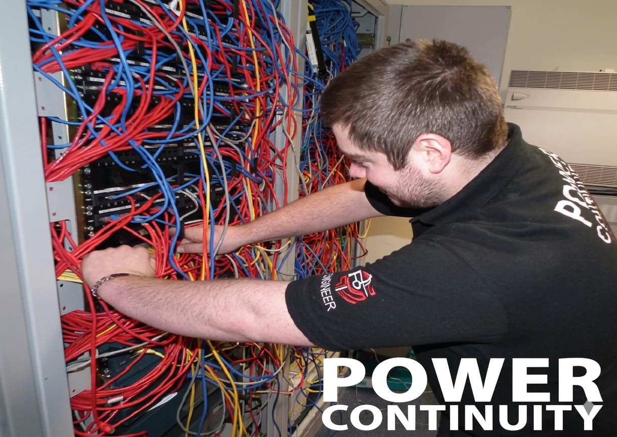Power continuity engineer working in a server room