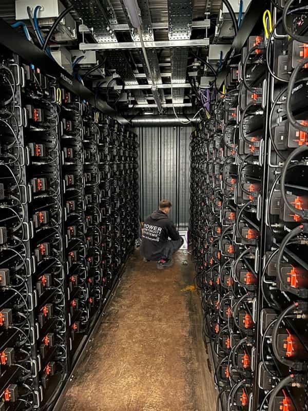 Power continuity engineer working inside a battery energy storage system (1)