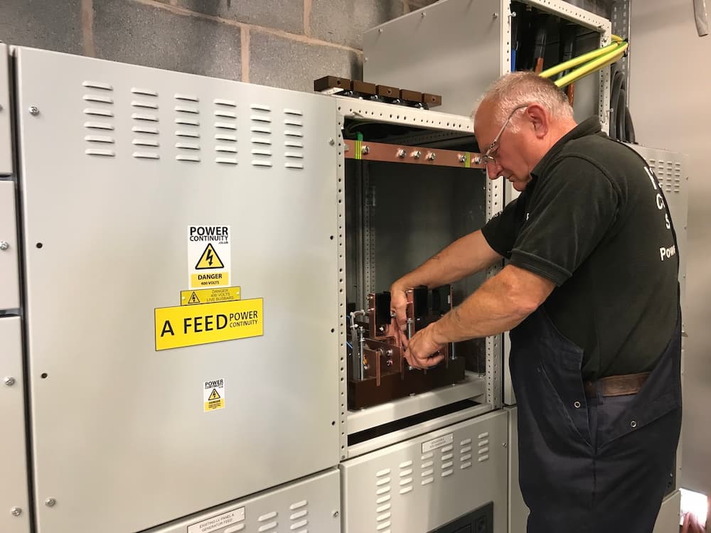 Power continuity engineer working on a lv mains panel