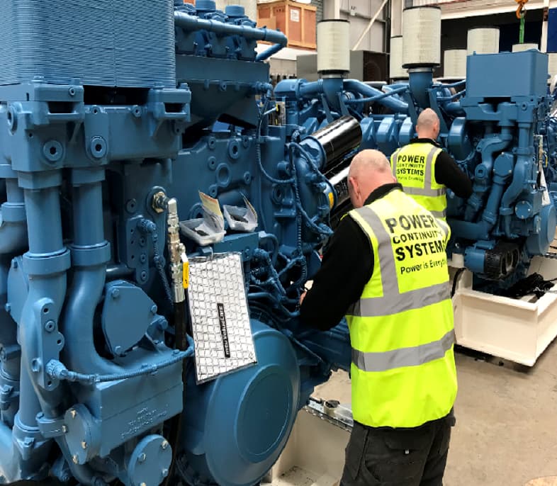 Power continuity engineer working on engine