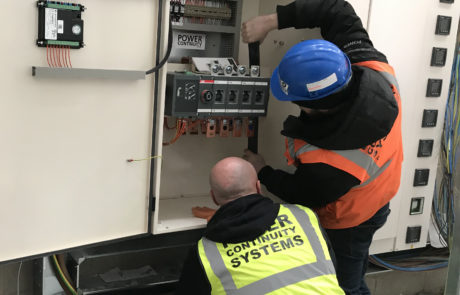 Power continuity engineers installing diesel generator