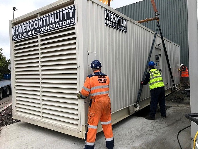 Power continuity engineers placing containerised generator