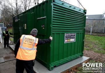 Power continuity engineers placing containerised generator on plinth