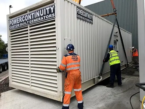Power continuity engineers placing containerised generator