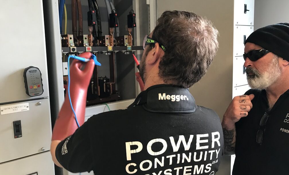 Power continuity engineers working on a lv mains panel