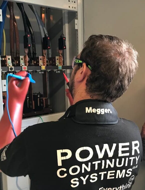 Power continuity engineers working on a lv mains panel