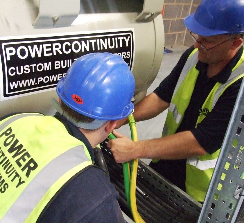 Power continuity engineers working on generator