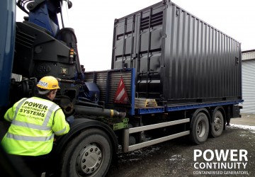 Power continuity lorry transporting black containerised diesel generator