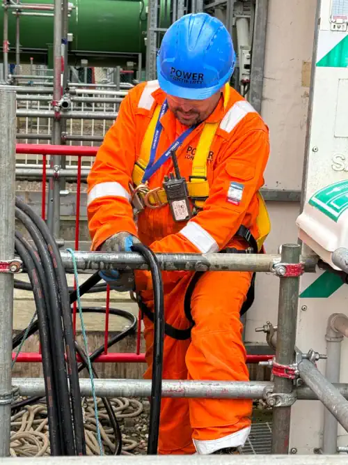 Hands of electrician working with electrical wiring in distribution board